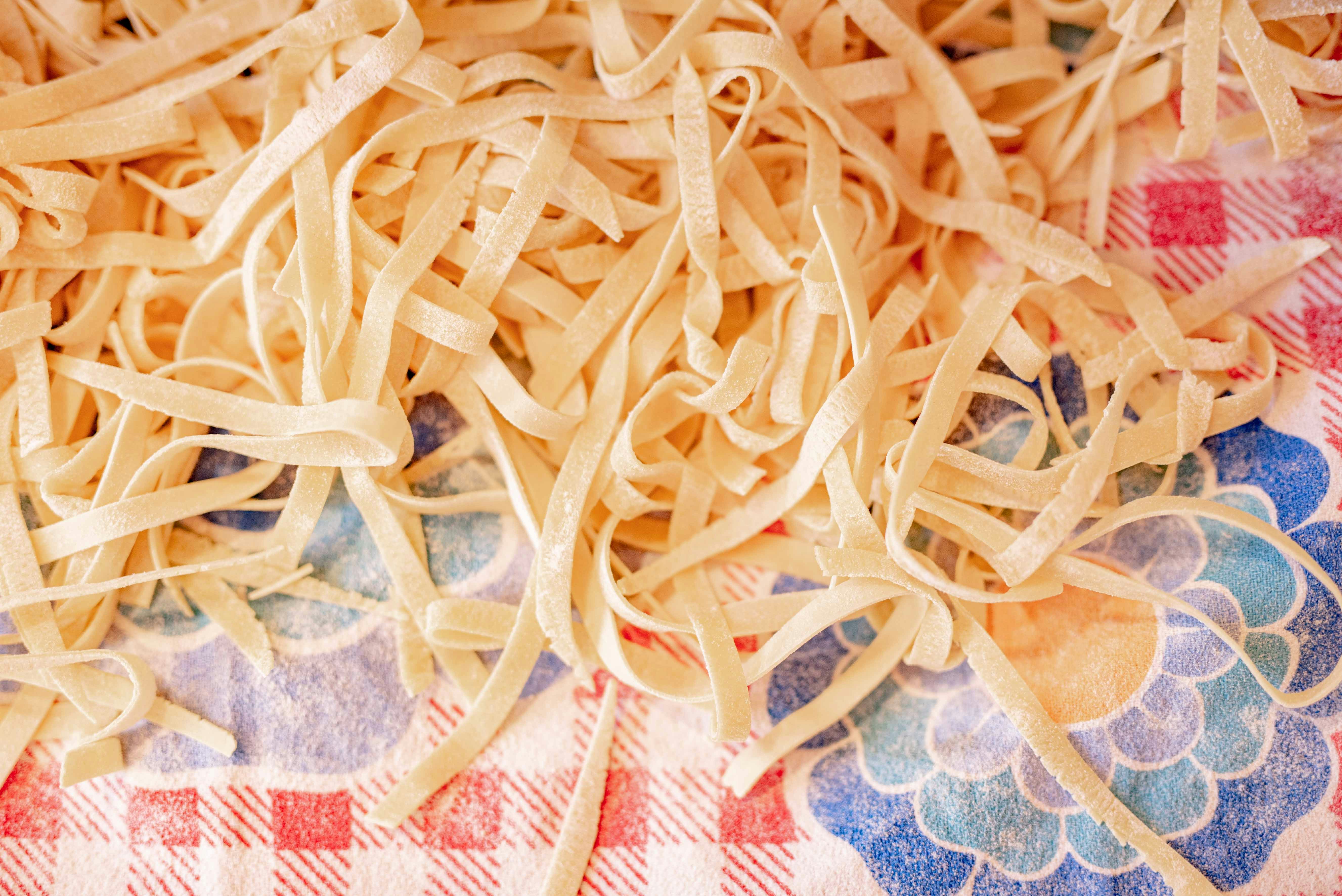 homemade pasta with red and white tablecloth with flowers